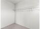 A bright closet features carpet and a single metal shelf for storage at 5615 Calais Ct, Las Vegas, NV 89118