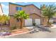 Inviting townhome with a two-car garage, desert landscaping, and manicured curb appeal at 5615 Calais Ct, Las Vegas, NV 89118