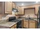 Well-equipped kitchen with wooden cabinetry, granite countertops and gas stove at 5615 Calais Ct, Las Vegas, NV 89118