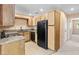Functional kitchen with a gas stove, wooden cabinetry and granite countertops at 5615 Calais Ct, Las Vegas, NV 89118