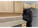 Kitchen featuring wooden cabinets, granite countertops and modern appliances at 5615 Calais Ct, Las Vegas, NV 89118