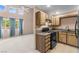 Bright kitchen featuring a gas stove, wooden cabinetry and adjacent living space at 5615 Calais Ct, Las Vegas, NV 89118
