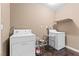 Functional laundry room with a washer, dryer, and convenient overhead shelving at 5615 Calais Ct, Las Vegas, NV 89118