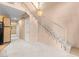 Living area view with staircase, open to the kitchen, and neutral color palette at 5615 Calais Ct, Las Vegas, NV 89118