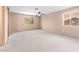 A spacious main bedroom with two large windows and neutral carpet at 5615 Calais Ct, Las Vegas, NV 89118