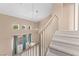 Staircase with carpeted steps leading to a loft area featuring clerestory windows at 5615 Calais Ct, Las Vegas, NV 89118