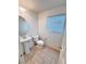 Cozy half-bathroom features pedestal sink and tile flooring at 5653 Mount Athos St, North Las Vegas, NV 89031