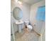 Cozy half-bathroom features pedestal sink and tile flooring at 5653 Mount Athos St, North Las Vegas, NV 89031