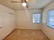 Bedroom with carpet flooring, ceiling fan, blind window and closet at 5653 Mount Athos St, North Las Vegas, NV 89031