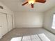Bedroom featuring a closet, ceiling fan, and carpeted floor at 5653 Mount Athos St, North Las Vegas, NV 89031