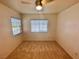 Bedroom featuring a ceiling fan, neutral carpeting, and a bright window at 5653 Mount Athos St, North Las Vegas, NV 89031