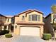 Charming two-story home with attached garage, landscaping, and neutral color palette at 5653 Mount Athos St, North Las Vegas, NV 89031