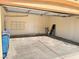 Large two-car garage featuring overhead storage and access door at 5653 Mount Athos St, North Las Vegas, NV 89031