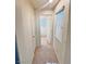 Upstairs hallway featuring carpet, neutral paint, and access to rooms at 5653 Mount Athos St, North Las Vegas, NV 89031
