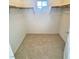 Spacious walk-in closet features carpet and a window for natural light and ventilation at 5653 Mount Athos St, North Las Vegas, NV 89031