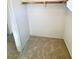 Carpeted walk-in closet with a hanging rod and shelf for storage and organization at 5653 Mount Athos St, North Las Vegas, NV 89031