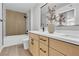 Contemporary bathroom featuring double sinks, a modern vanity, and marble-look shower at 5710 E Tropicana Ave # 2152, Las Vegas, NV 89122