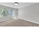 Bright bedroom featuring a large window, neutral color scheme, and carpeted floors at 5710 E Tropicana Ave # 2152, Las Vegas, NV 89122
