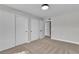 Bright bedroom featuring neutral tones, carpet, and large closets with entry to another room at 5710 E Tropicana Ave # 2152, Las Vegas, NV 89122