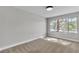 Sunlit bedroom with ample space and a large window with views of the surrounding greenery at 5710 E Tropicana Ave # 2152, Las Vegas, NV 89122