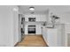 Bright kitchen featuring white cabinetry, stainless steel appliances, and light wood flooring at 5710 E Tropicana Ave # 2152, Las Vegas, NV 89122