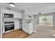 Updated kitchen features white cabinets, stainless steel appliances, and an open layout to the living room at 5710 E Tropicana Ave # 2152, Las Vegas, NV 89122
