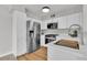 Clean kitchen with white cabinets, stainless steel appliances, and light wood flooring, providing a modern feel at 5710 E Tropicana Ave # 2152, Las Vegas, NV 89122
