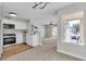 Open-concept kitchen with white cabinets flows into the living area with a large window at 5710 E Tropicana Ave # 2152, Las Vegas, NV 89122