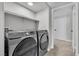 Contemporary laundry room featuring modern washer and dryer and white trim at 5710 E Tropicana Ave # 2152, Las Vegas, NV 89122