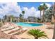 Resort-style pool area with lounge chairs and umbrellas, perfect for relaxation and leisure at 5710 E Tropicana Ave # 2152, Las Vegas, NV 89122