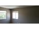 Neutral-toned bedroom featuring dual windows allowing natural light at 574 Roxella Ln # C, Las Vegas, NV 89110