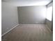 Spacious living room featuring neutral walls and carpet, with a bright window to let in natural light at 574 Roxella Ln # C, Las Vegas, NV 89110