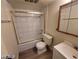 Tiled bathroom featuring a shower over the bathtub and a neutral-colored single sink vanity at 615 S Royal Crest Cir # 10, Las Vegas, NV 89169