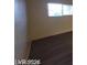 Cozy bedroom featuring modern hardwood flooring and a large window at 615 S Royal Crest Cir # 10, Las Vegas, NV 89169