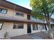 Two-story apartment building with a concrete walkway and neutral-colored exterior paint at 615 S Royal Crest Cir # 10, Las Vegas, NV 89169