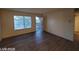 Spacious living room with modern hardwood flooring and a sliding glass door to the balcony at 615 S Royal Crest Cir # 10, Las Vegas, NV 89169