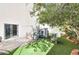 Backyard featuring artificial grass, a playhouse, patio area and lush foliage at 6233 Overhang Ave, Henderson, NV 89011