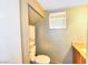 Cozy half-bathroom featuring a granite countertop, toilet, and storage shelves at 6233 Overhang Ave, Henderson, NV 89011