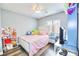 Well-lit bedroom with a pink bed and colorful decor at 6233 Overhang Ave, Henderson, NV 89011