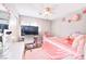 Well-organized bedroom with pink accents and a ceiling fan at 6233 Overhang Ave, Henderson, NV 89011