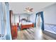 Cozy bedroom featuring wood floors, a ceiling fan, and a four-poster bed at 6233 Overhang Ave, Henderson, NV 89011