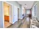 Bright hallway with a view to the laundry room and half-bathroom at 6233 Overhang Ave, Henderson, NV 89011