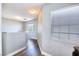 Bright hallway featuring wood floors and white walls, creating a clean and modern aesthetic at 6233 Overhang Ave, Henderson, NV 89011