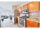 Well-lit kitchen featuring stainless steel appliances, granite countertops, and wooden cabinets at 6233 Overhang Ave, Henderson, NV 89011