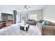 Cozy living room with comfortable sofas, a ceiling fan, and sliding glass doors to the backyard at 6233 Overhang Ave, Henderson, NV 89011