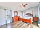 Comfortable main bedroom boasts a king bed, dresser, ceiling fan and windows with natural light at 6233 Overhang Ave, Henderson, NV 89011