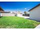 Expansive backyard with lush green grass and mature trees, offering a private and serene outdoor space at 633 5Th St, Boulder City, NV 89005