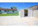 A backyard featuring a storage shed on a concrete patio, set against a lush green lawn and a clear blue sky at 633 5Th St, Boulder City, NV 89005