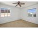 A room with neutral carpet gets plenty of natural light from the two windows at 633 5Th St, Boulder City, NV 89005