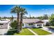Inviting single-story home featuring mature palm trees and a well-maintained front lawn in a quiet neighborhood at 633 5Th St, Boulder City, NV 89005